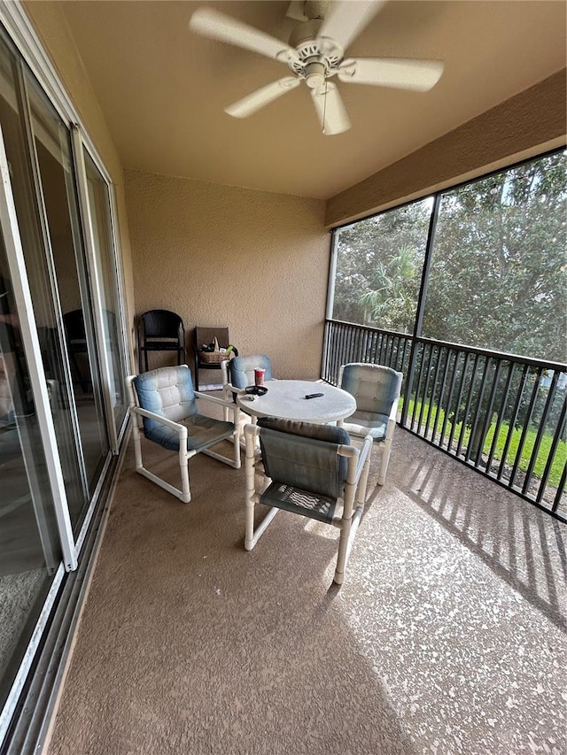 sunroom featuring ceiling fan