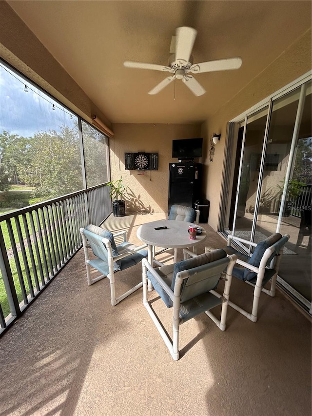 exterior space with ceiling fan and a balcony