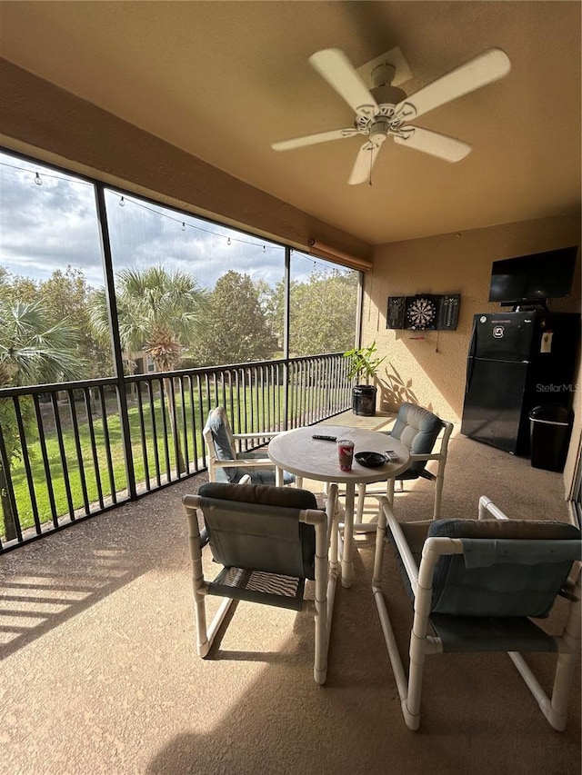 sunroom / solarium with a wealth of natural light and ceiling fan