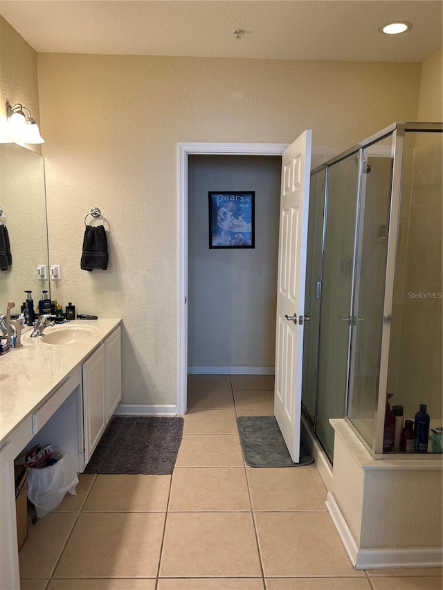 bathroom featuring an enclosed shower, vanity, and tile patterned floors