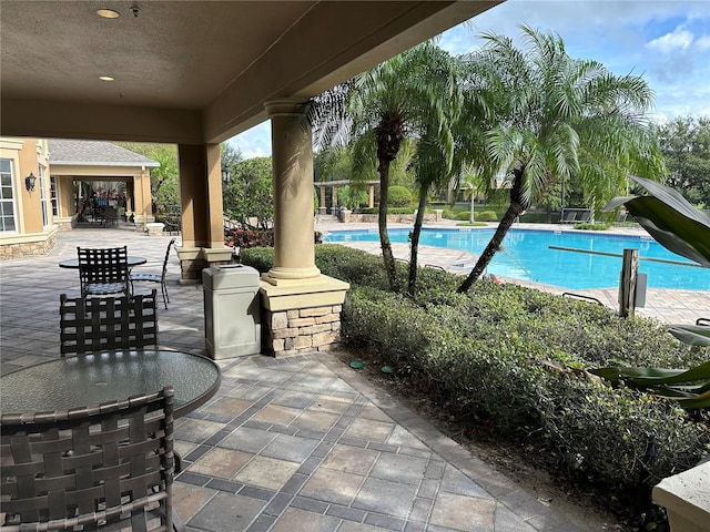 view of swimming pool with a patio area