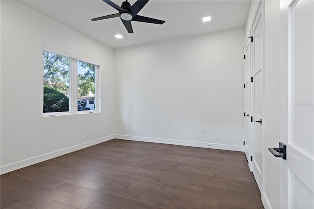 empty room featuring ceiling fan and dark hardwood / wood-style floors