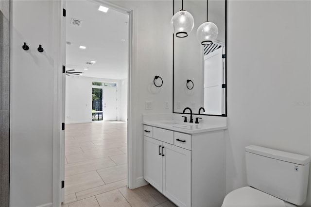 bathroom featuring toilet and vanity