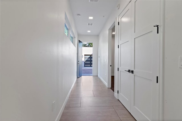 corridor featuring light tile patterned floors