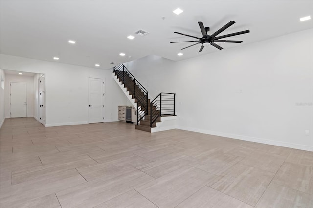 unfurnished living room featuring ceiling fan