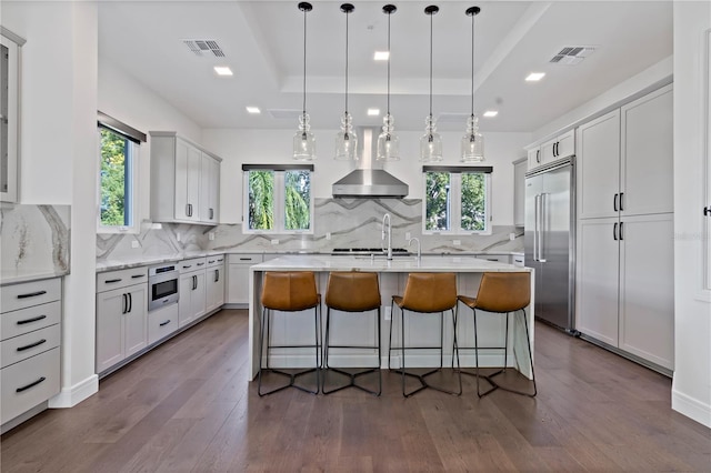 kitchen featuring a kitchen island with sink, stainless steel appliances, and plenty of natural light