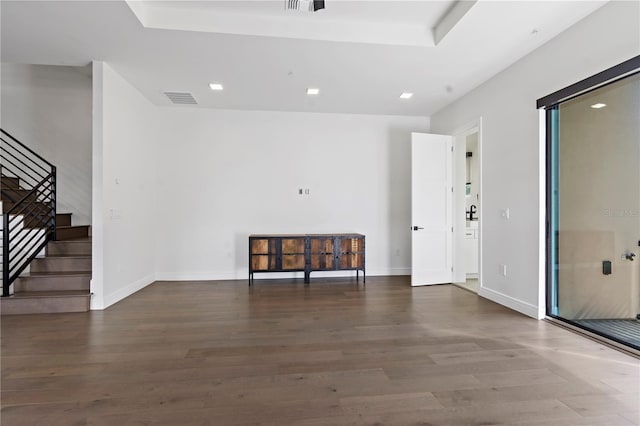 unfurnished room with dark wood-type flooring