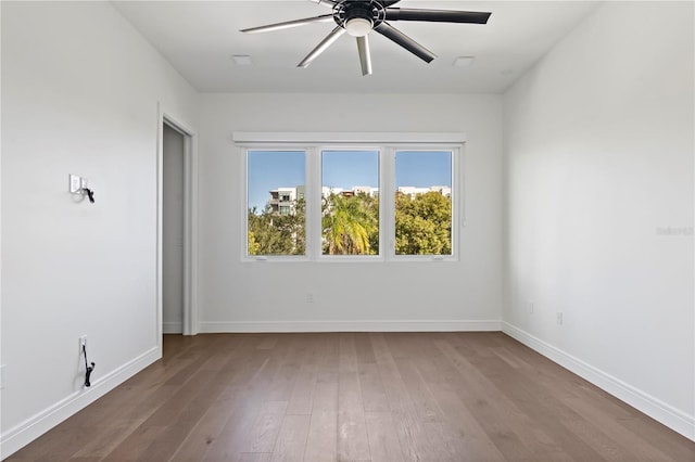 empty room featuring hardwood / wood-style floors and ceiling fan