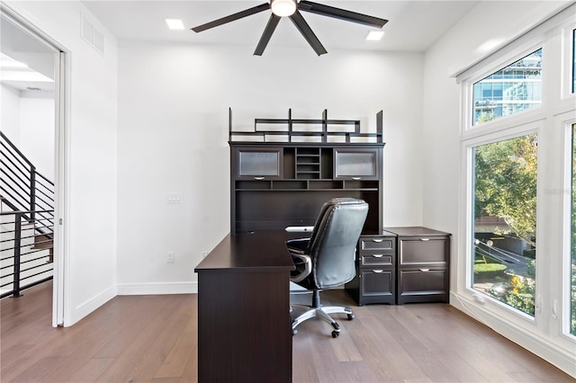 office space featuring light hardwood / wood-style flooring and ceiling fan