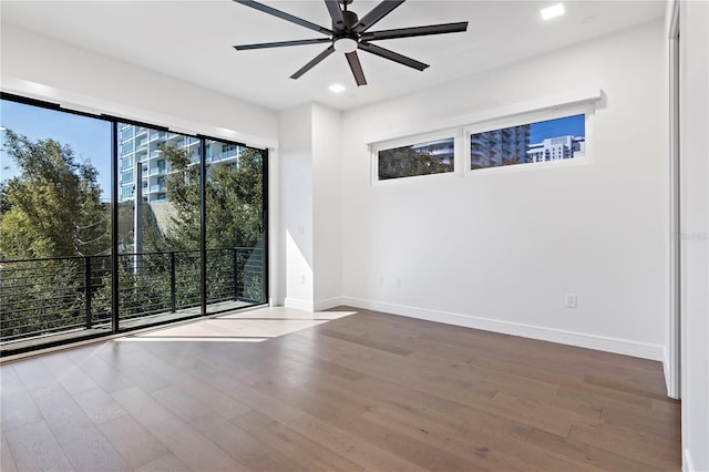 empty room with hardwood / wood-style flooring and ceiling fan