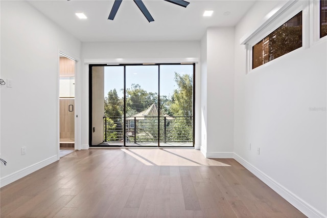 unfurnished room with light hardwood / wood-style flooring, a healthy amount of sunlight, and ceiling fan