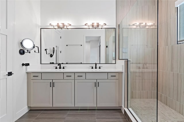 bathroom with vanity and a tile shower