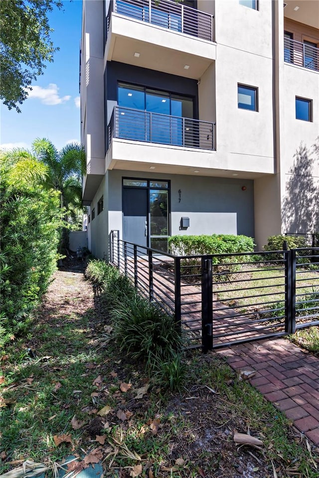 back of property featuring a balcony