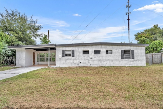 view of front of home with a front yard and a carport