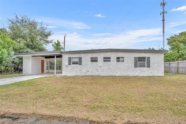 exterior space with a carport and a front yard