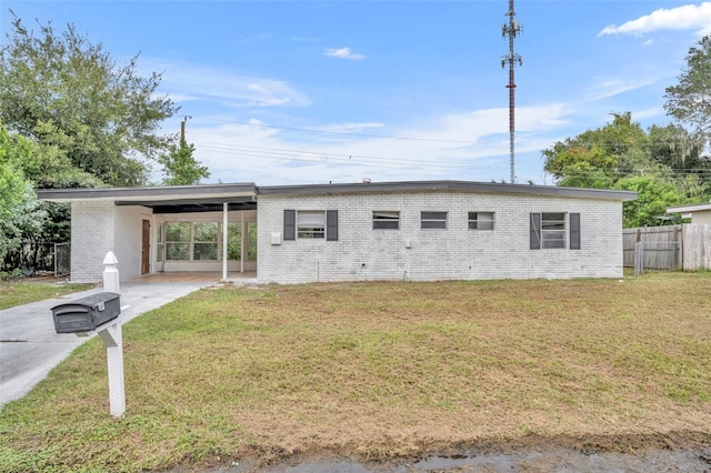 view of front of property featuring a carport and a front lawn