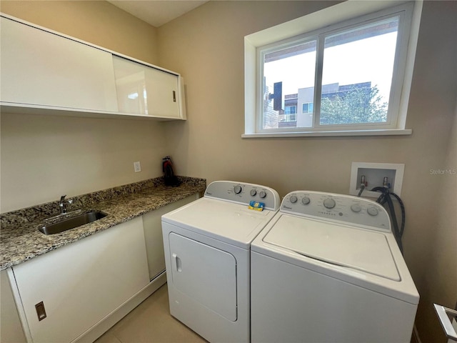 laundry room featuring cabinets, sink, and independent washer and dryer