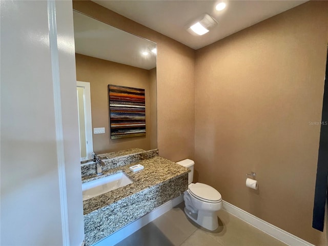 bathroom with vanity, tile patterned floors, and toilet