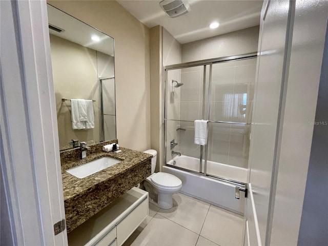 full bathroom with toilet, vanity, tile patterned flooring, and enclosed tub / shower combo