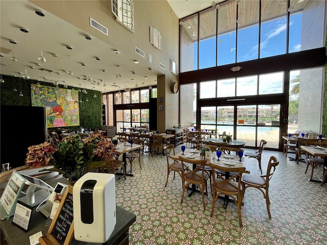 dining area with a towering ceiling