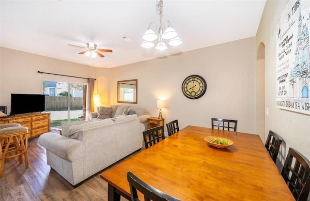 dining room featuring hardwood / wood-style floors and ceiling fan with notable chandelier