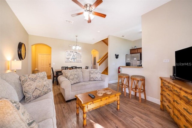 3520 Calabria Ave Unit 3520, Davenport, FL 33897 - living room featuring arched walkways, ceiling fan, baseboards, wood finished floors, and a chandelier