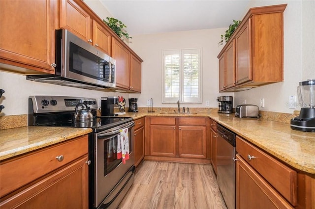 3520 Calabria Ave Unit 3520, Davenport, FL 33897 - kitchen with appliances with stainless steel finishes, a sink, and brown cabinets