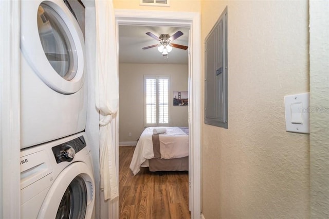 3520 Calabria Ave Unit 3520, Davenport, FL 33897 - laundry room with stacked washing machine and dryer, wood finished floors, a ceiling fan, a textured wall, and baseboards