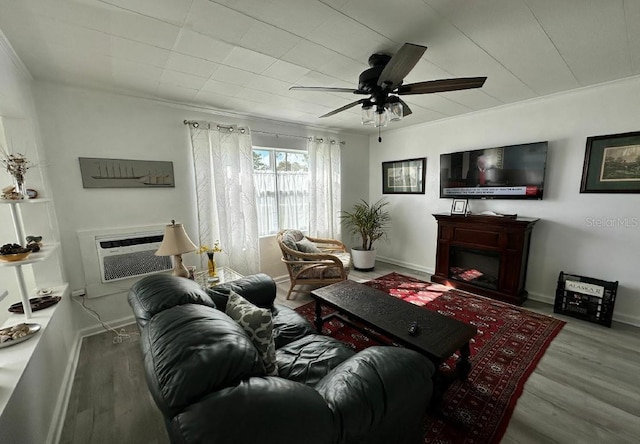 living room with ornamental molding, hardwood / wood-style flooring, ceiling fan, and a wall mounted AC