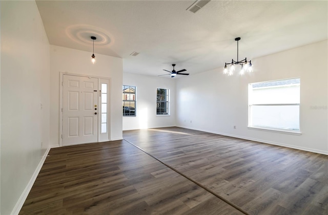 foyer entrance featuring dark hardwood / wood-style floors, a healthy amount of sunlight, and ceiling fan with notable chandelier