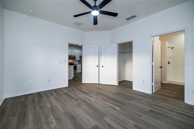 unfurnished bedroom featuring ceiling fan and dark wood-type flooring