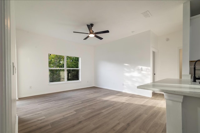 unfurnished living room featuring light hardwood / wood-style flooring and ceiling fan