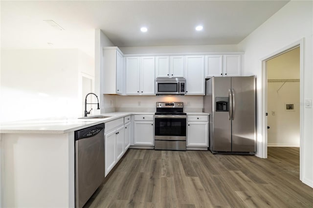 kitchen featuring white cabinets, dark hardwood / wood-style flooring, sink, and appliances with stainless steel finishes