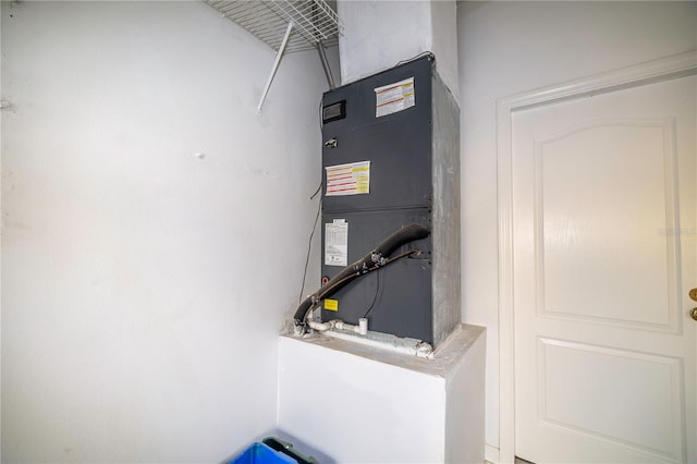 utility room featuring heating unit