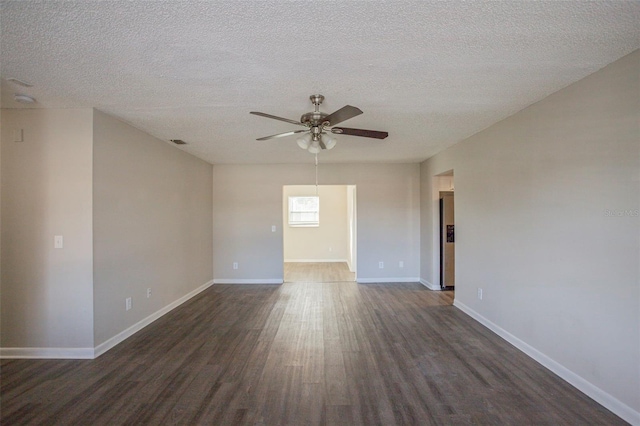 empty room featuring a textured ceiling, ceiling fan, and dark wood-type flooring