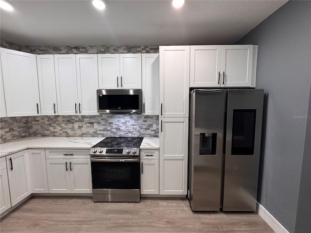 kitchen with stainless steel appliances and white cabinets