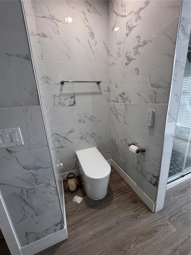 bathroom with toilet and hardwood / wood-style floors