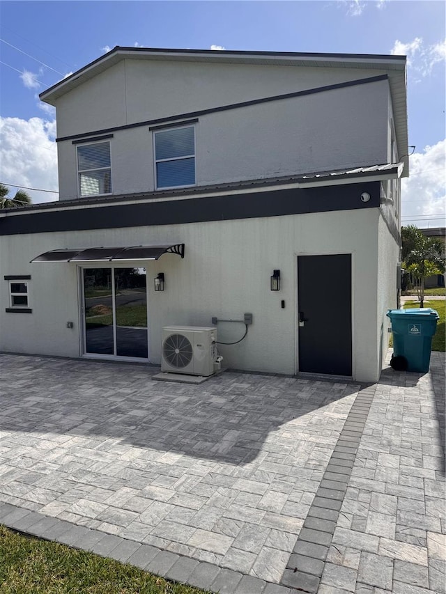 back of house with ac unit and a patio