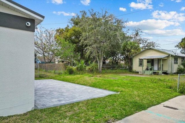 view of yard with entry steps, a patio area, and fence