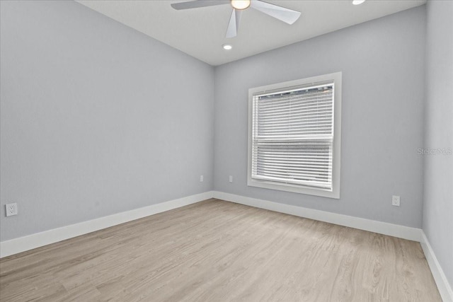 empty room featuring light wood-type flooring, ceiling fan, baseboards, and recessed lighting