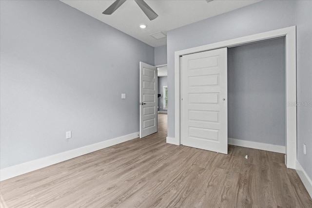 unfurnished bedroom with a closet, wood finished floors, a ceiling fan, and baseboards