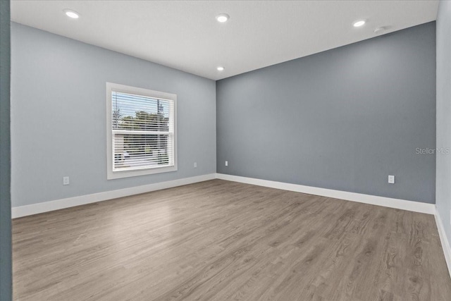 empty room featuring baseboards and wood finished floors