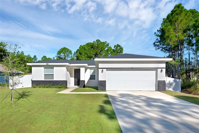 view of front of home with a garage and a front lawn