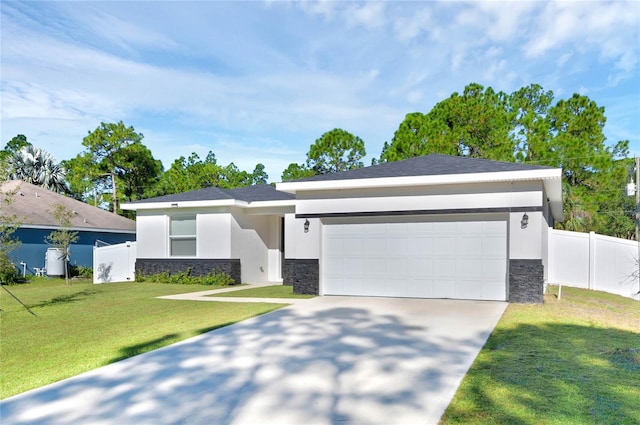 view of front of home featuring a garage and a front lawn