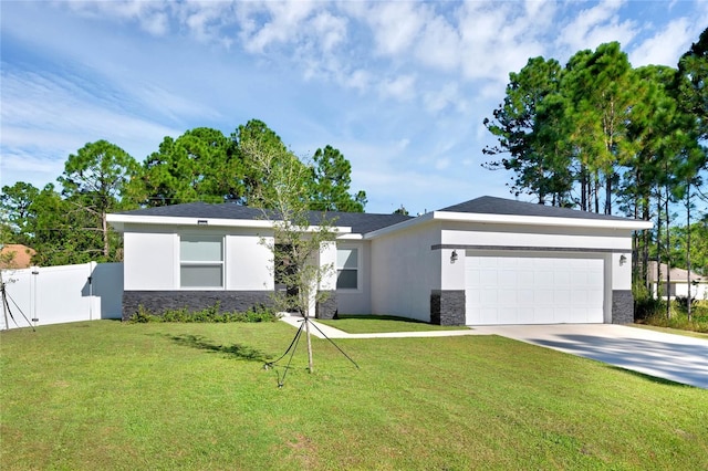 single story home featuring a garage and a front yard