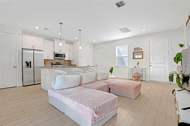 living room with light hardwood / wood-style flooring