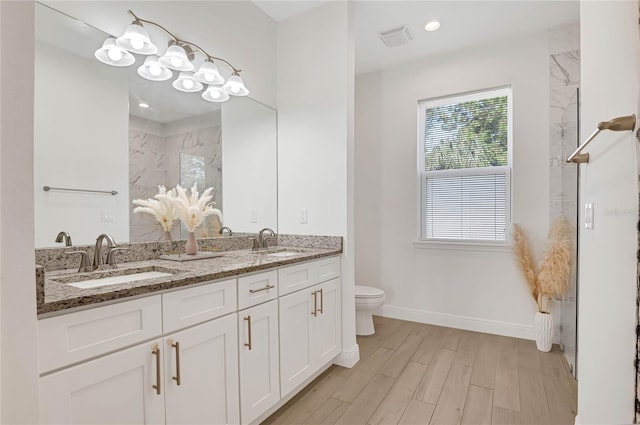 bathroom featuring wood-type flooring, toilet, and vanity