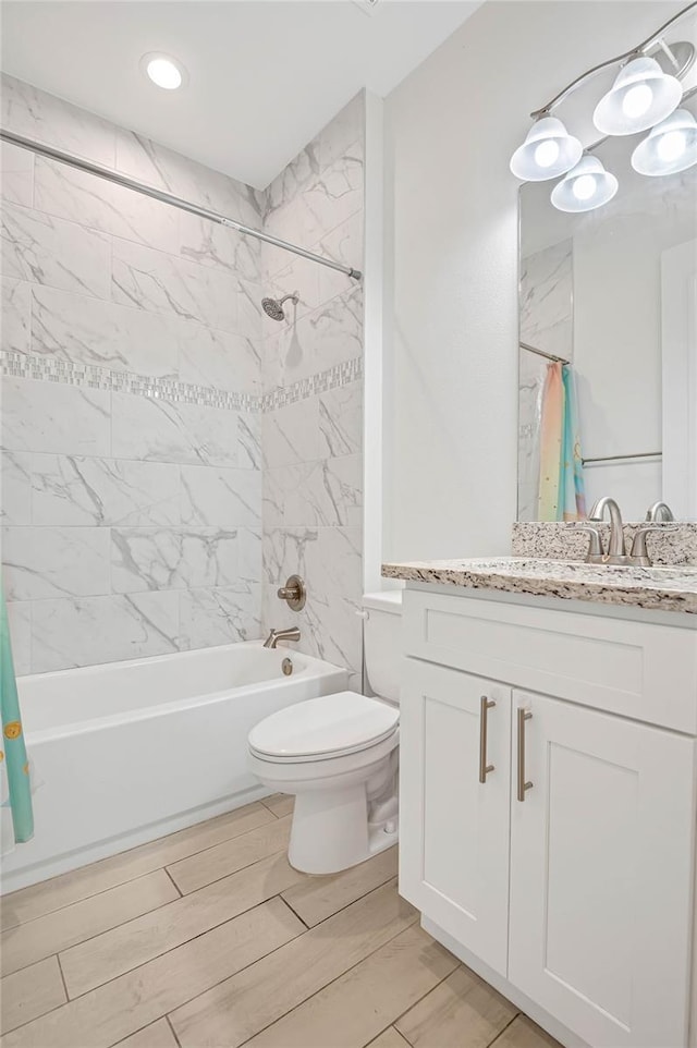 full bathroom featuring vanity, shower / bath combo with shower curtain, and toilet