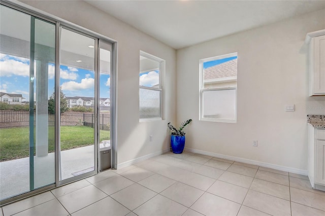 entryway with light tile patterned floors