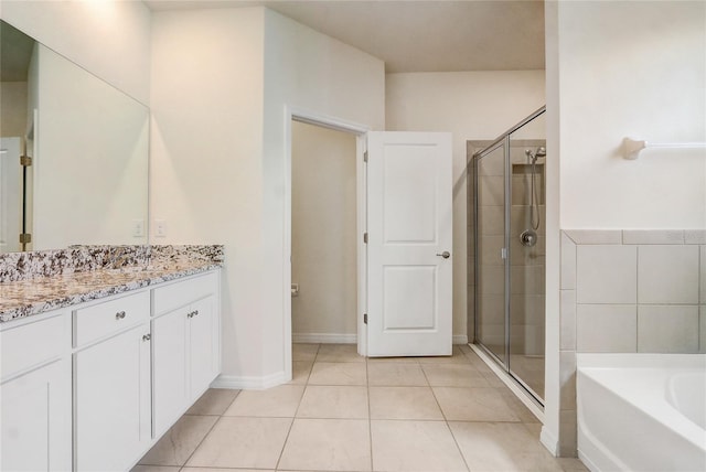 bathroom with tile patterned floors, vanity, and independent shower and bath